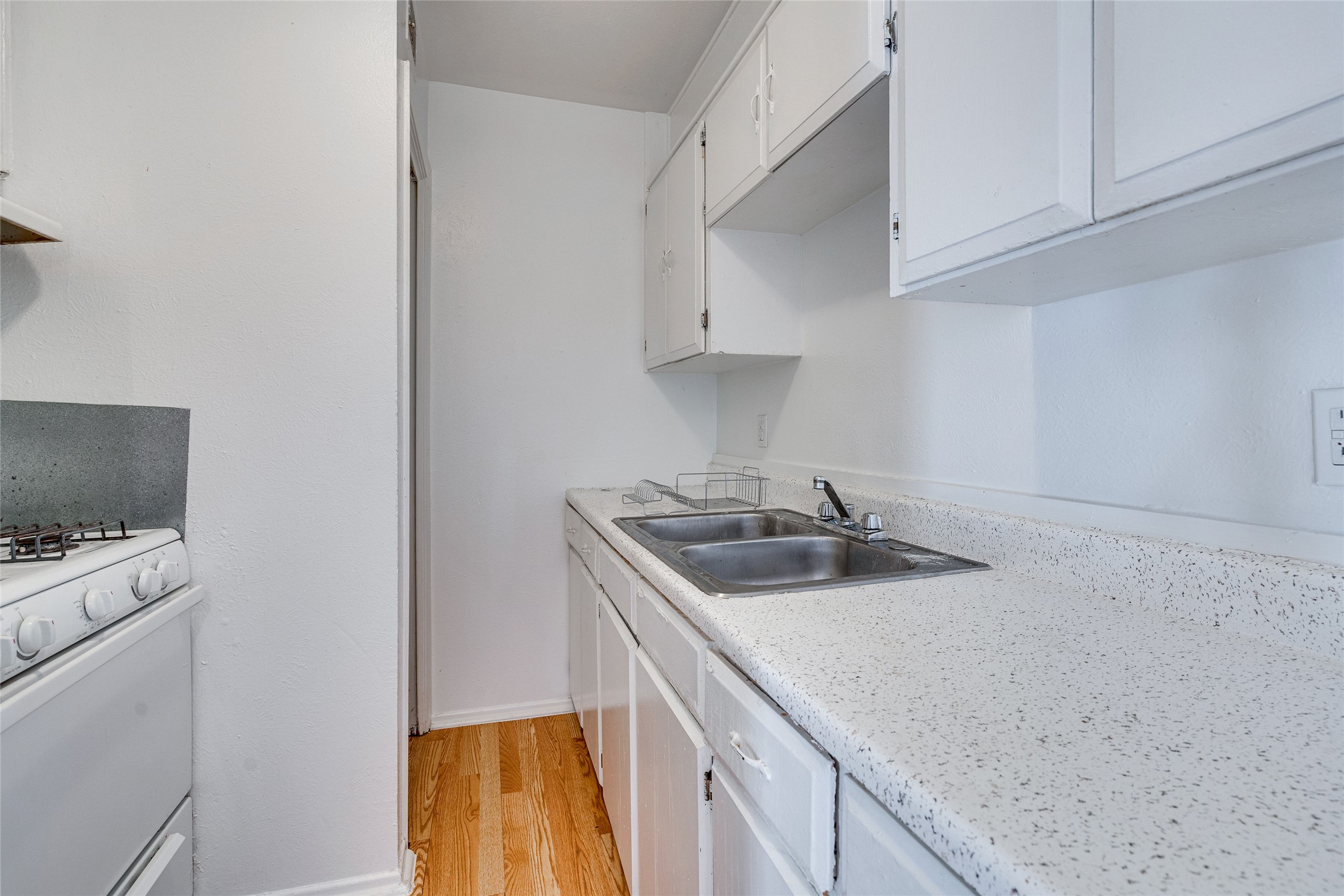 307 East 31st Street, Unit 107 Austin, TX 78705 - Photo 8 of 16 a kitchen with a sink and a stove top oven