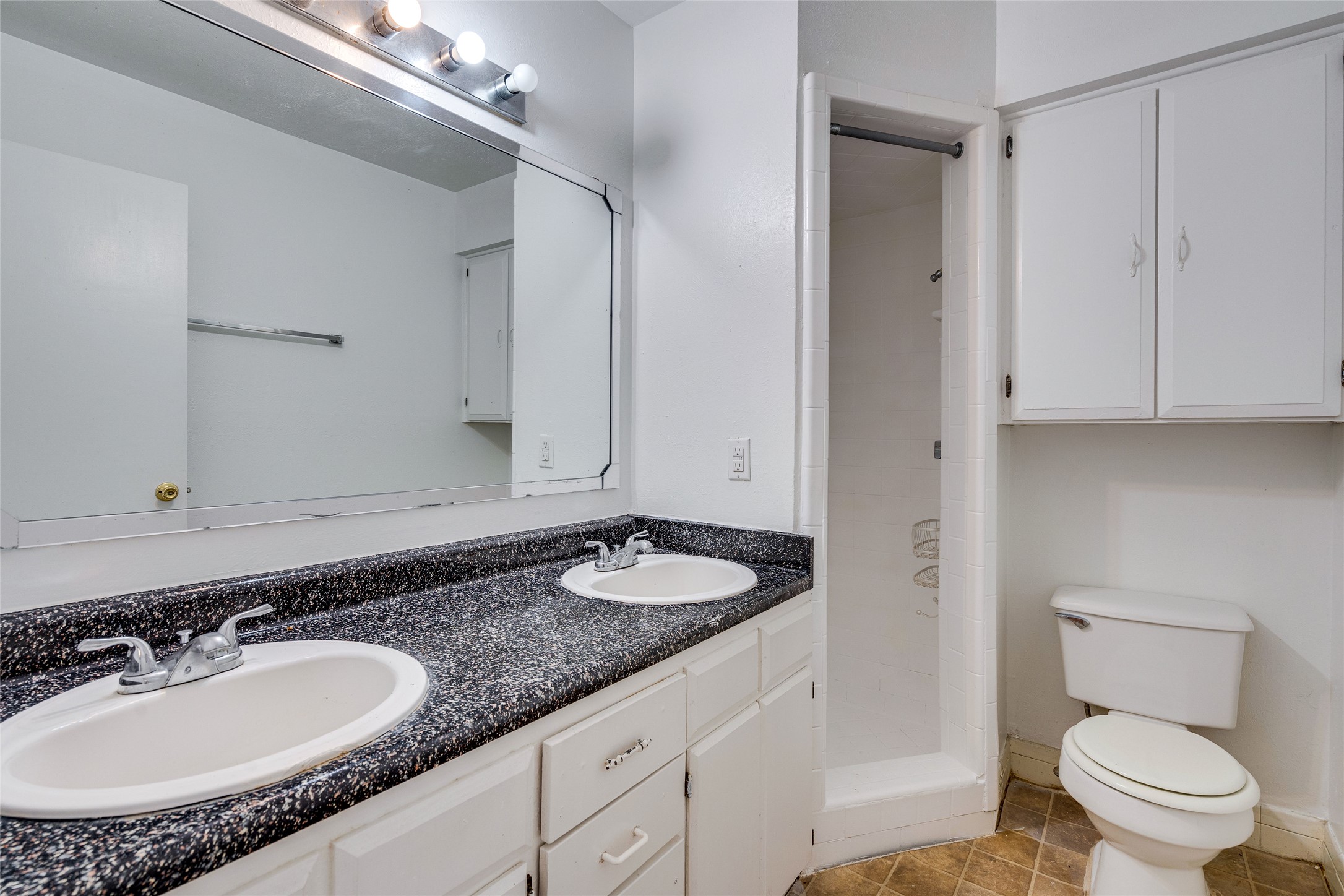 307 East 31st Street, Unit 107 Austin, TX 78705 - Photo 10 of 16 a bathroom with a granite countertop sink and a mirror