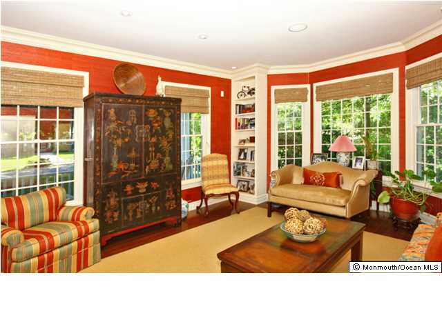 20 Robin Road Rumson, NJ 07760 - Photo 3 of 16 a living room with furniture a flat screen tv and a floor to ceiling window