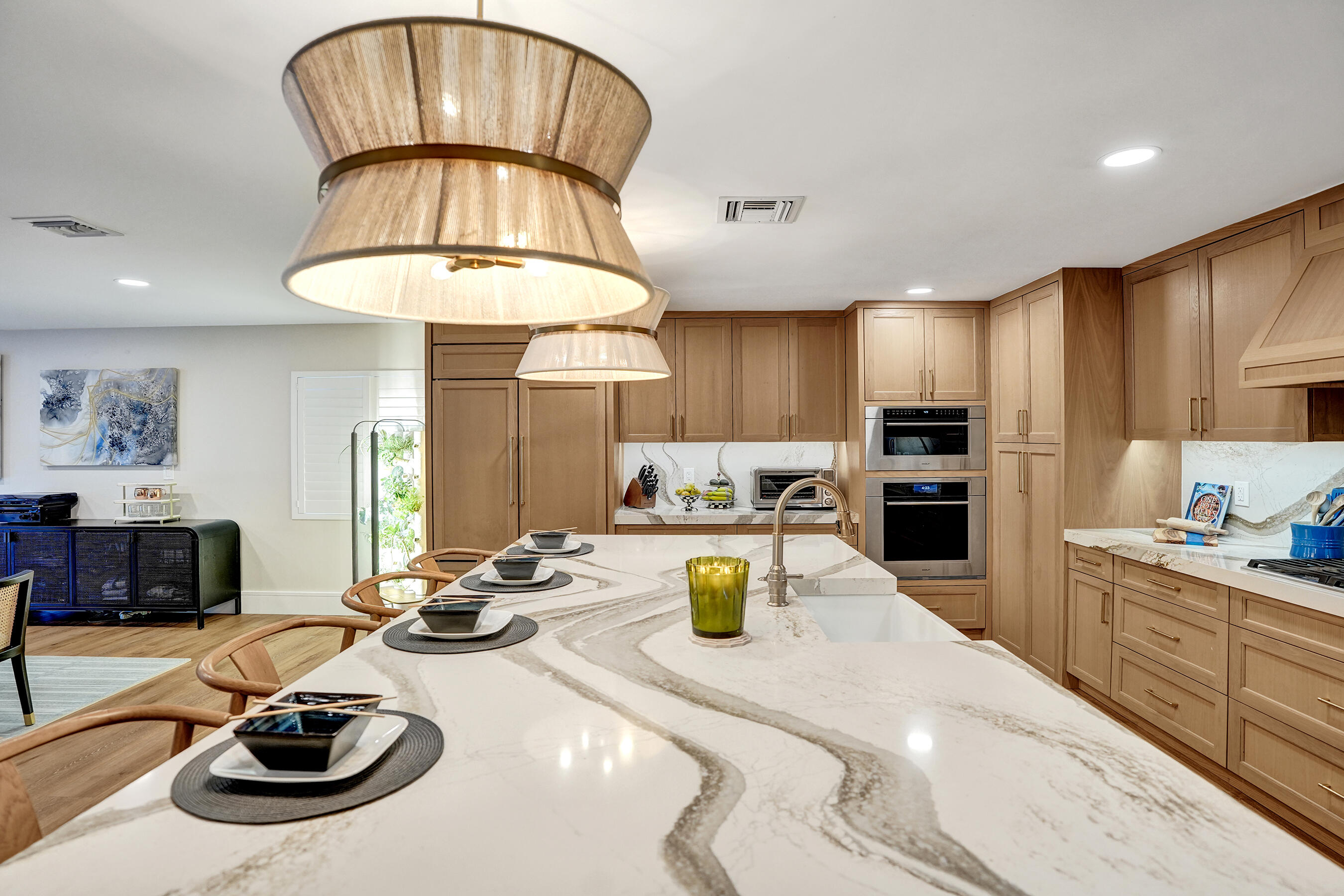 3681 Northwest 24th Terrace Boca Raton, FL 33431 - Photo 16 of 78 a kitchen with sink refrigerator dining table and chairs