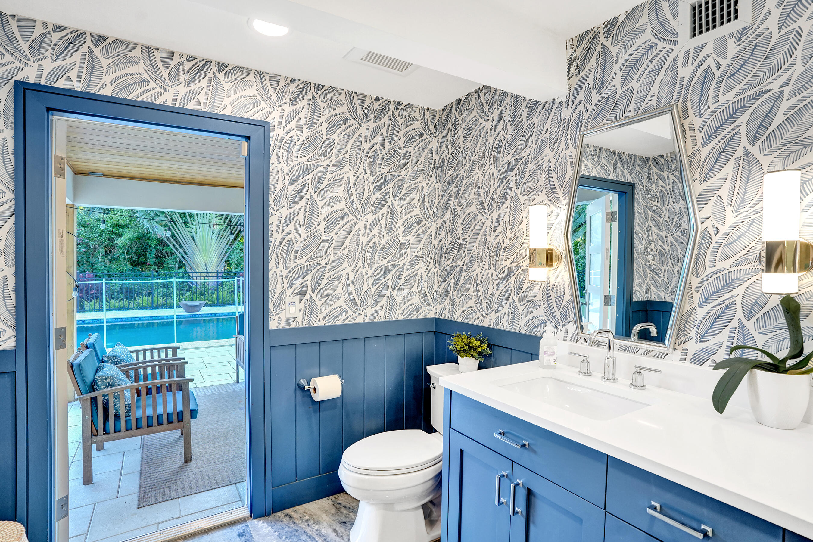 3681 Northwest 24th Terrace Boca Raton, FL 33431 - Photo 39 of 78 a bathroom with a granite countertop toilet a sink a mirror and a shower
