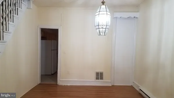 a view of a livingroom with wooden floor and window