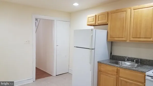 a kitchen with a refrigerator and cabinets