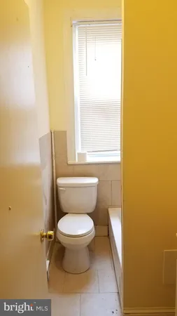 a white toilet sitting next to a window