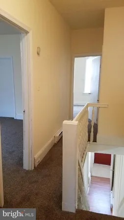 a view of living room couch and a window with wooden floor