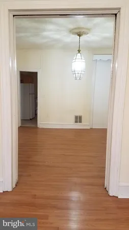 a view of a room with wooden floor and staircase