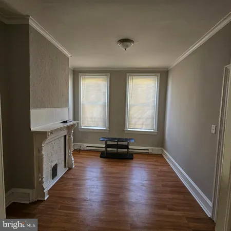 a view of kitchen with sink and wooden floor