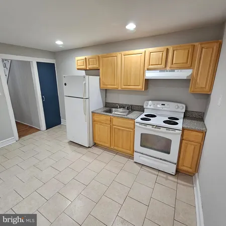 a kitchen with a stove a sink and a refrigerator