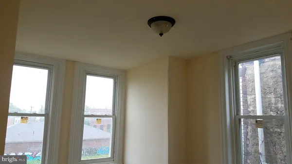 a view of an empty room and a window