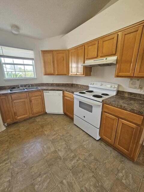 294 Limestone Circle Crestview, FL 32539 - Photo 5 of 9 a kitchen with stainless steel appliances granite countertop a stove sink and cabinets