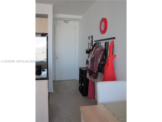 79 Southwest 12th Street, Unit 2911S Miami, FL 33130 - Photo 3 of 9 a view of walk in closet with clothes and shoes