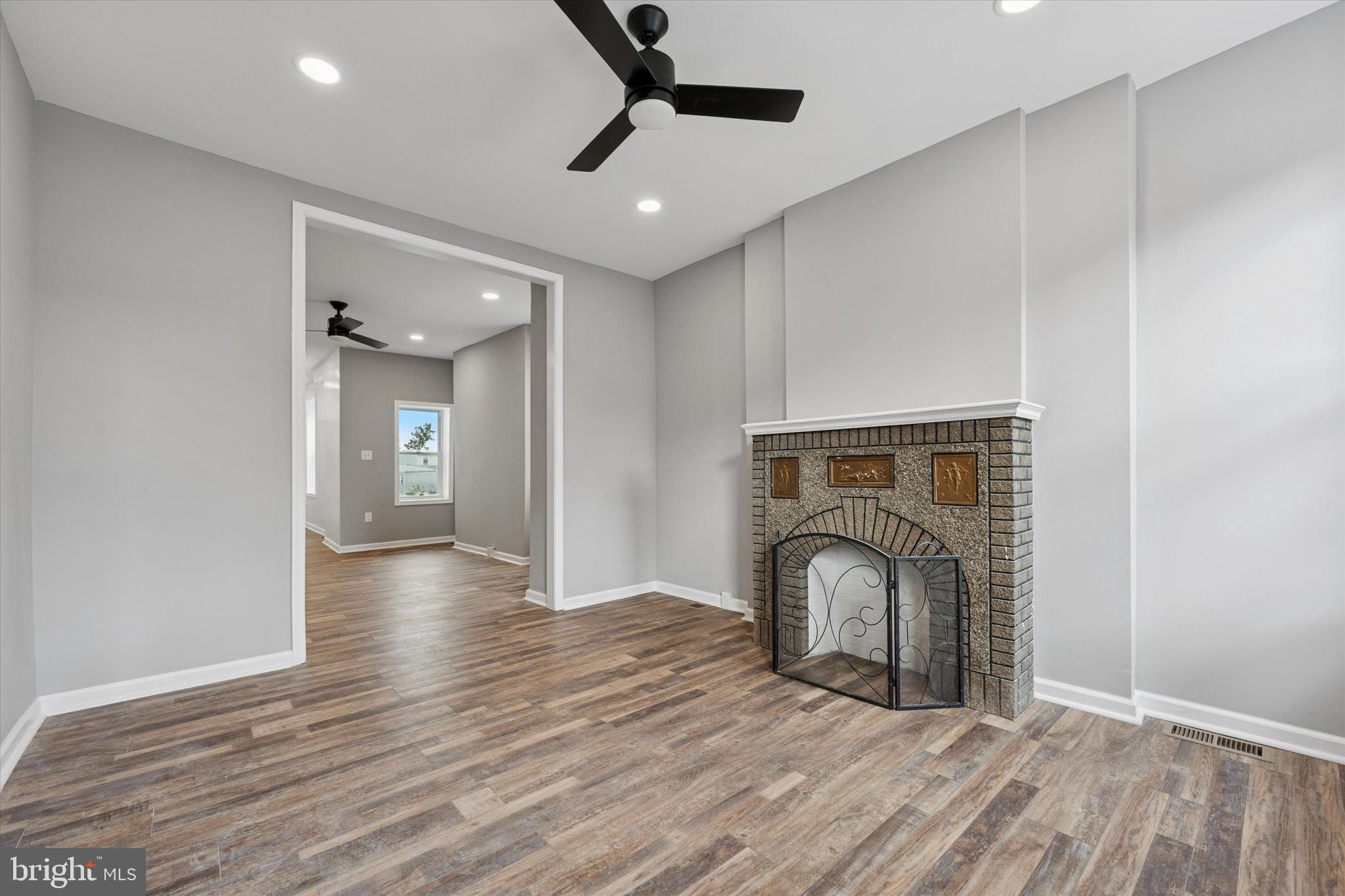 425 Grove Street Bridgeport, PA 19405 - Photo 2 of 24 a view of empty room with wooden floor and fireplace
