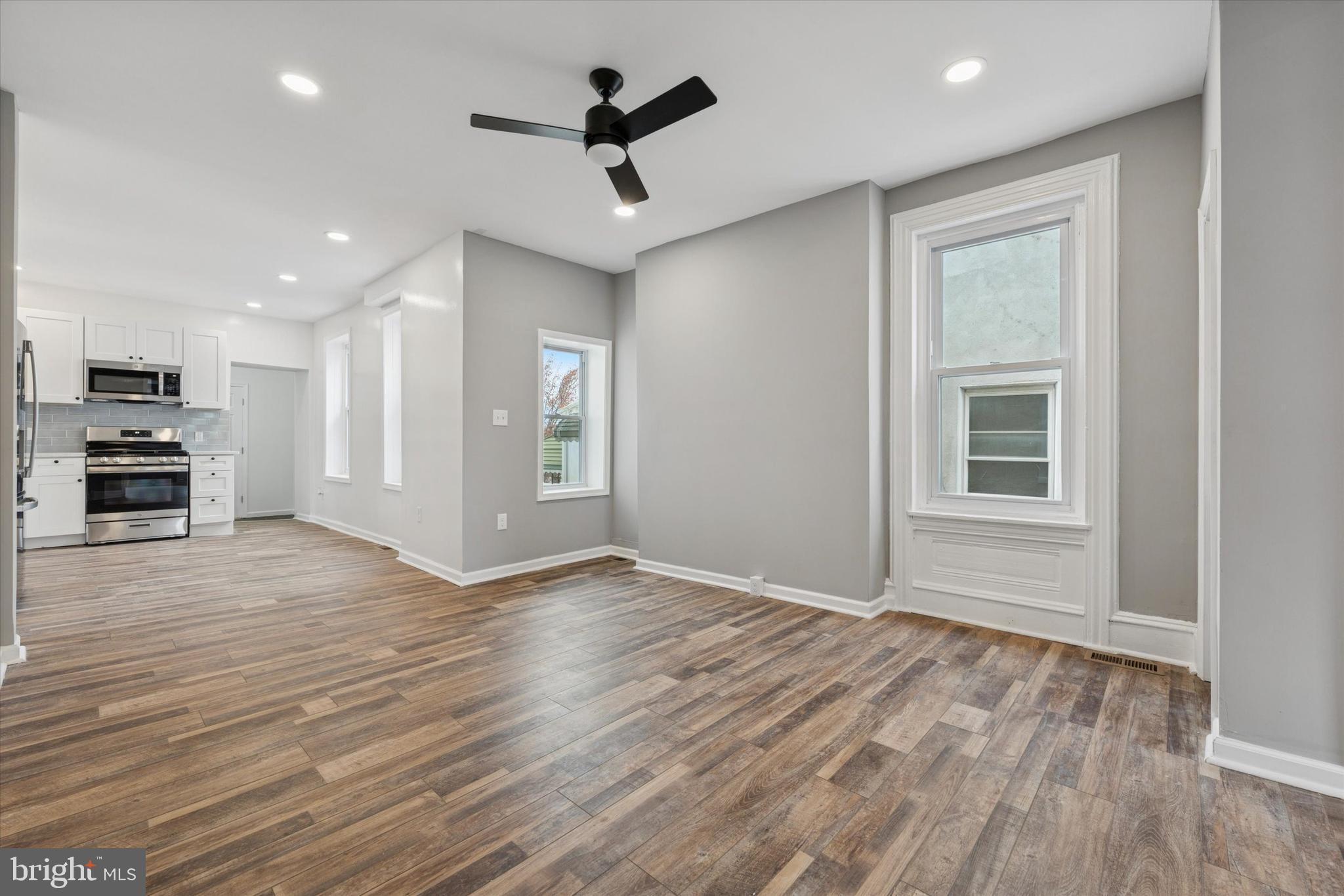 425 Grove Street Bridgeport, PA 19405 - Photo 4 of 24 an empty room with wooden floor and windows