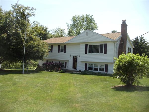 17 Meadow Road Ware, MA 01082 - Photo 1 of 15 a front view of a house with a garden and trees