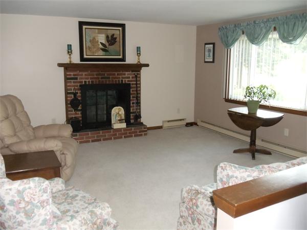 17 Meadow Road Ware, MA 01082 - Photo 2 of 15 a living room with furniture a window and a fireplace