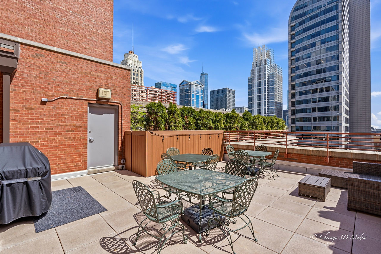208 West Washington Street, Unit 1007 Chicago, IL 60606 - Photo 5 of 18 a view of a patio with couches table and chairs and potted plants