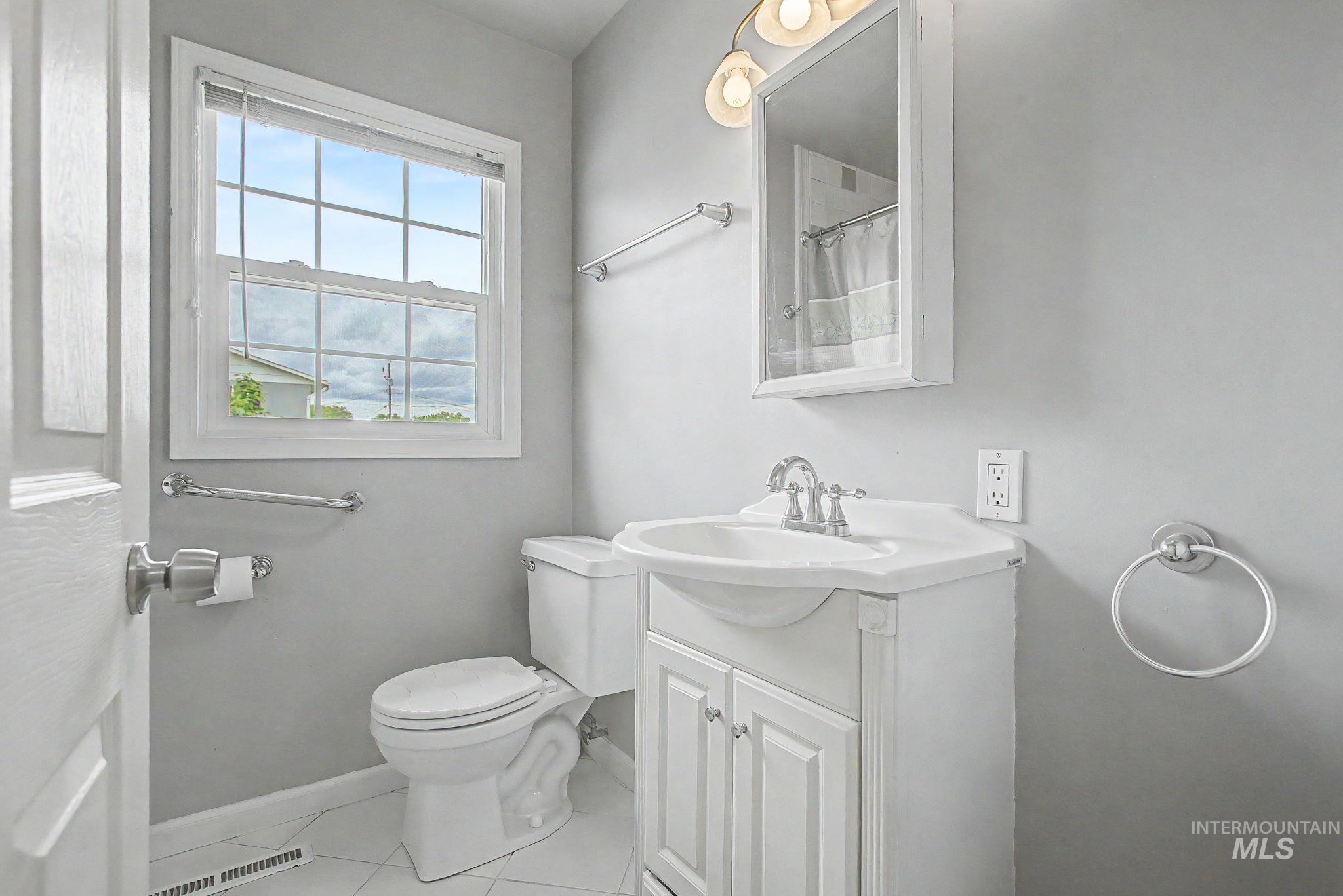 3314 6th Street Lewiston, ID 83501 - Photo 26 of 50 Bathroom with a white vanity featuring cabinet storage and a white integrated sink