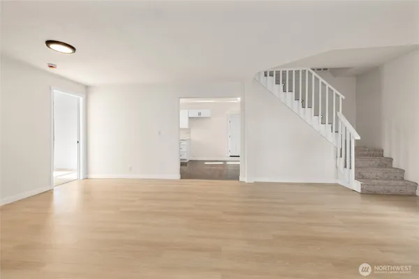 a view of an empty room with wooden floor