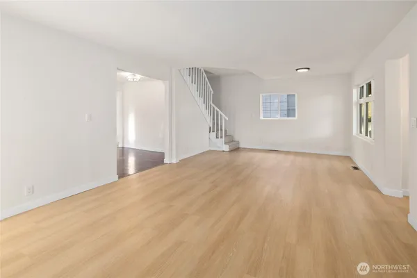 a view of empty room with wooden floor