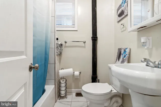 a white toilet sitting next to a bathroom sink
