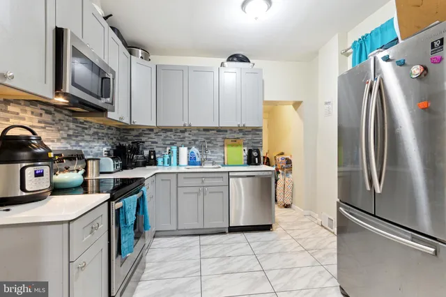 a kitchen with a refrigerator sink and microwave