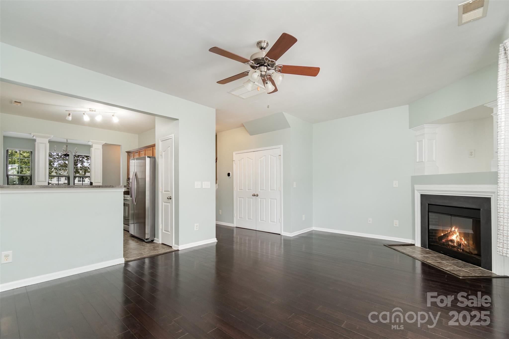 7367 Laurel Valley Road Charlotte, NC 28273 - Photo 11 of 21 a view of an empty room with wooden floor and a fireplace