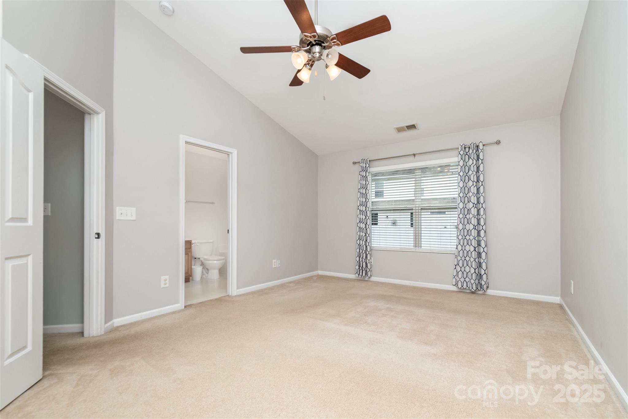 7367 Laurel Valley Road Charlotte, NC 28273 - Photo 14 of 21 an empty room with chandelier fan and windows