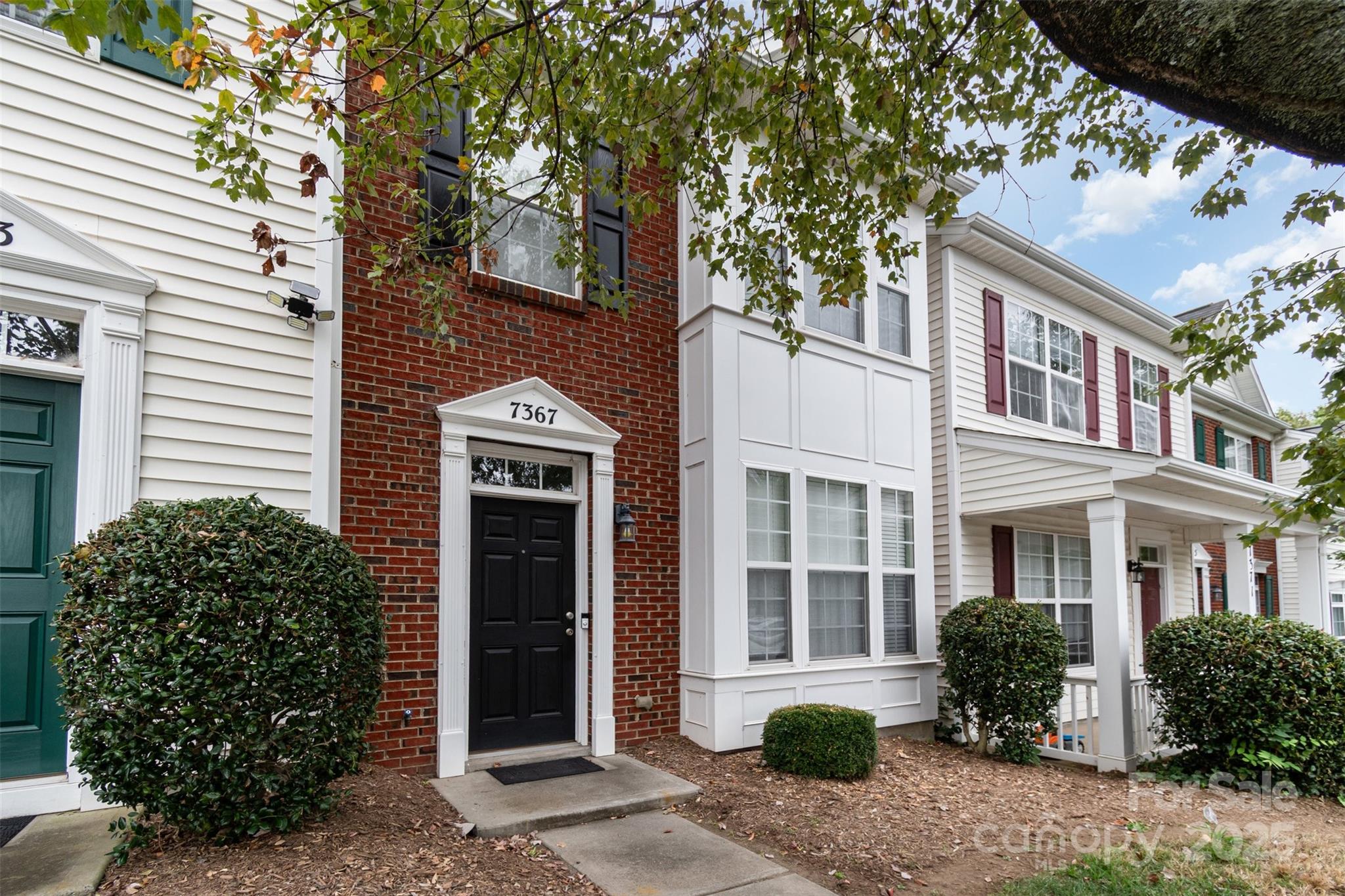 7367 Laurel Valley Road Charlotte, NC 28273 - Photo 3 of 21 a front view of a house with a yard