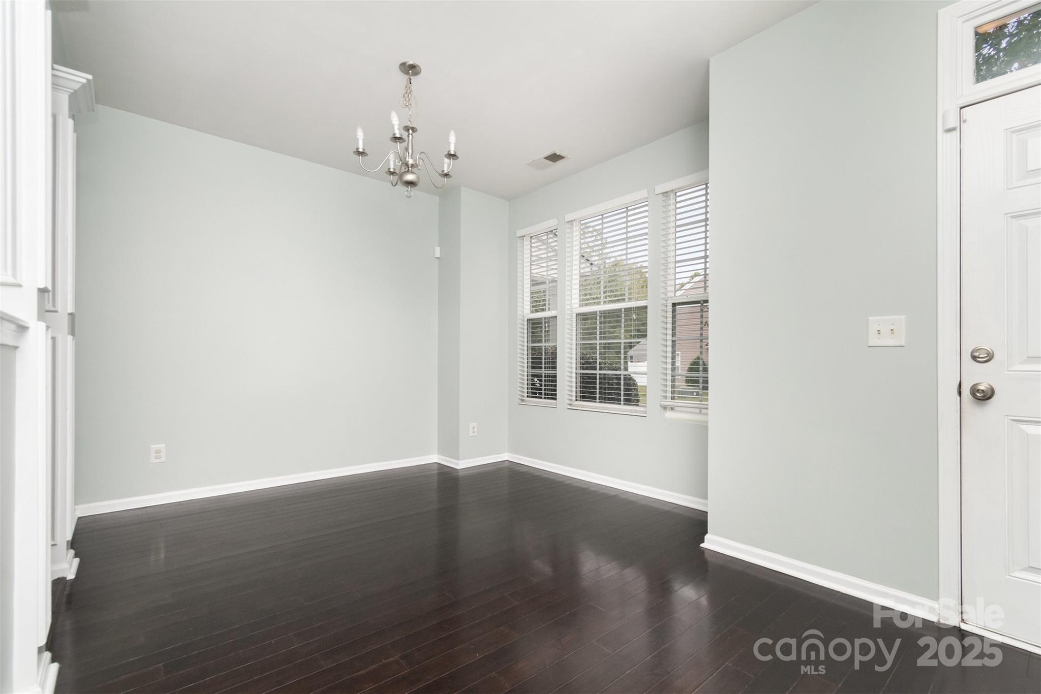 7367 Laurel Valley Road Charlotte, NC 28273 - Photo 4 of 21 a view of an empty room with wooden floor and a window