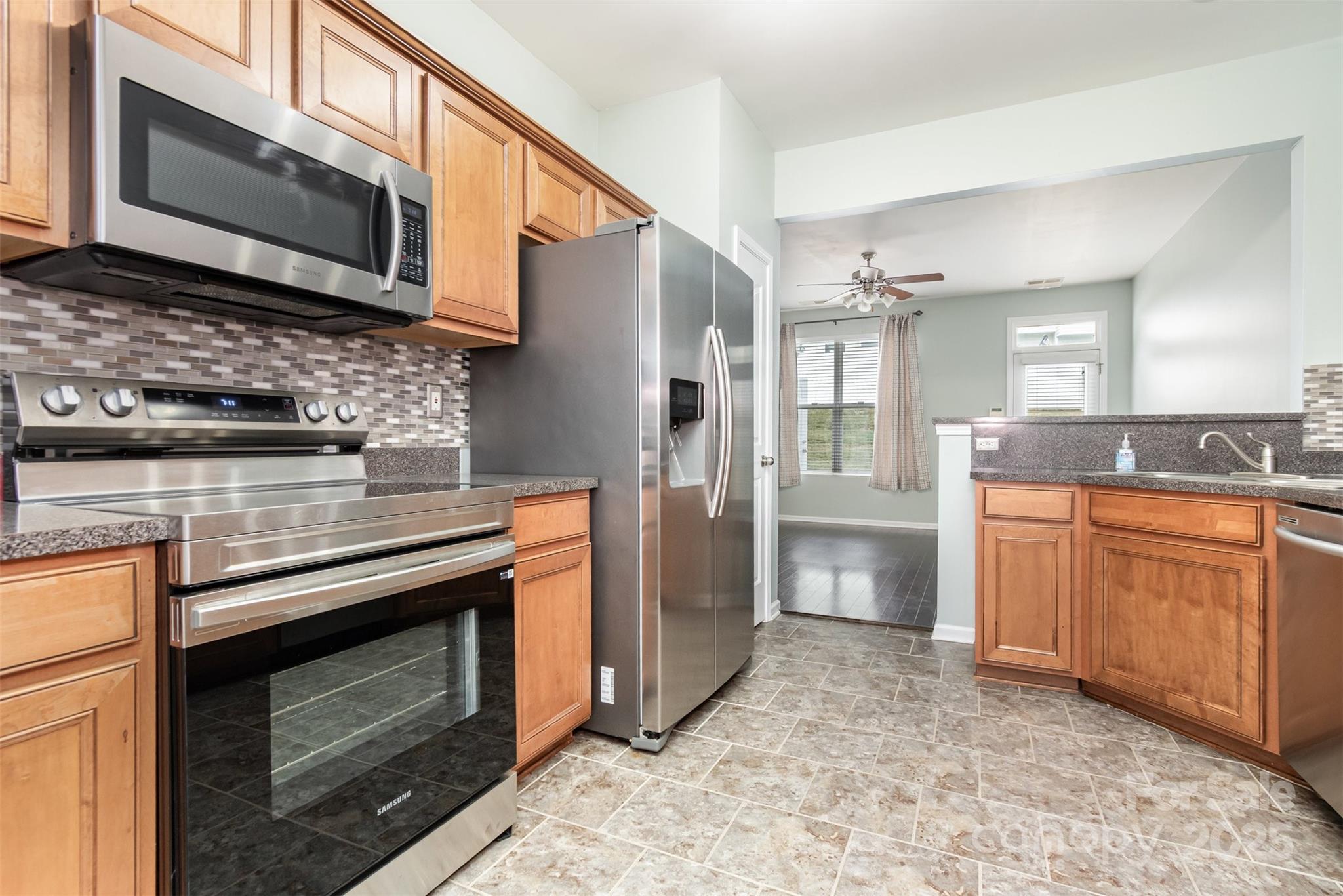 7367 Laurel Valley Road Charlotte, NC 28273 - Photo 8 of 21 a kitchen with stainless steel appliances granite countertop a stove microwave and refrigerator