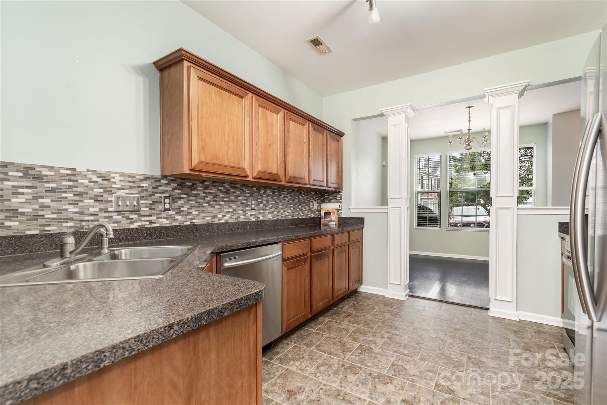 7367 Laurel Valley Road Charlotte, NC 28273 - Photo 9 of 21 a kitchen with stainless steel appliances granite countertop a sink stove and refrigerator