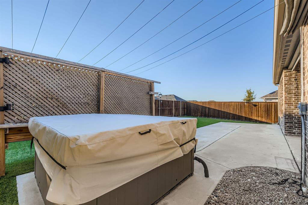 312 Magnolia Drive Oak Point, TX 75068 - Photo 26 of 28 Fenced backyard with a patio area and a hot tub