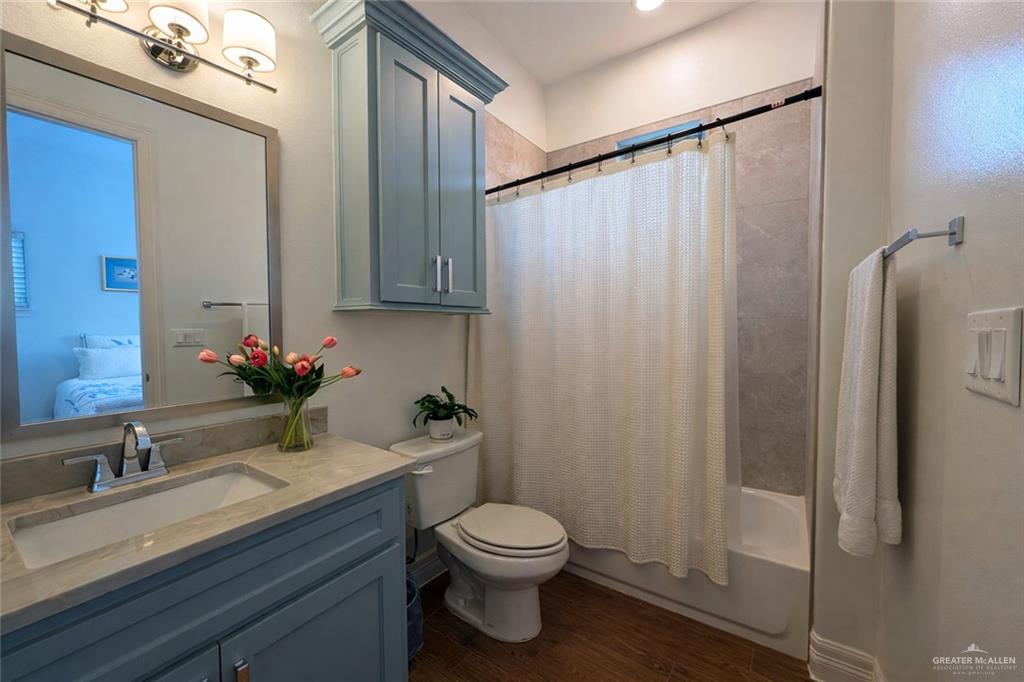 805 Grayson Avenue McAllen, TX 78504 - Photo 12 of 31 a bathroom with a sink a toilet a shower and a mirror