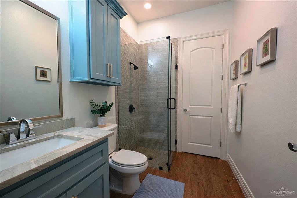 805 Grayson Avenue McAllen, TX 78504 - Photo 15 of 31 a bathroom with a granite countertop sink toilet and shower