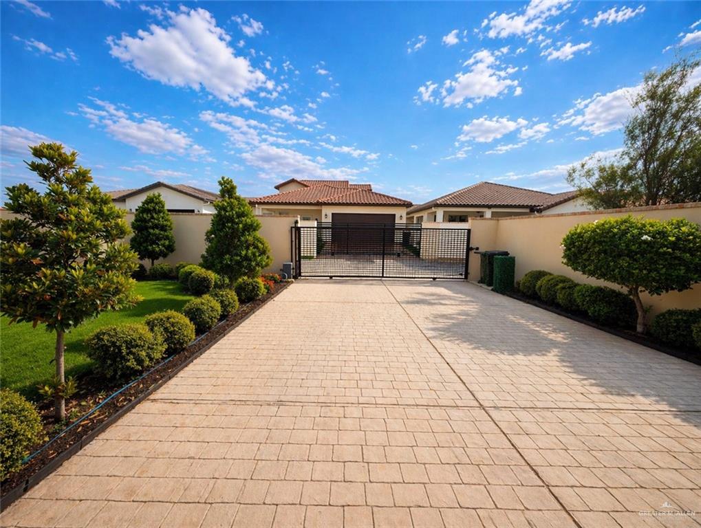 805 Grayson Avenue McAllen, TX 78504 - Photo 25 of 31 a view of a white house with a yard and potted plants