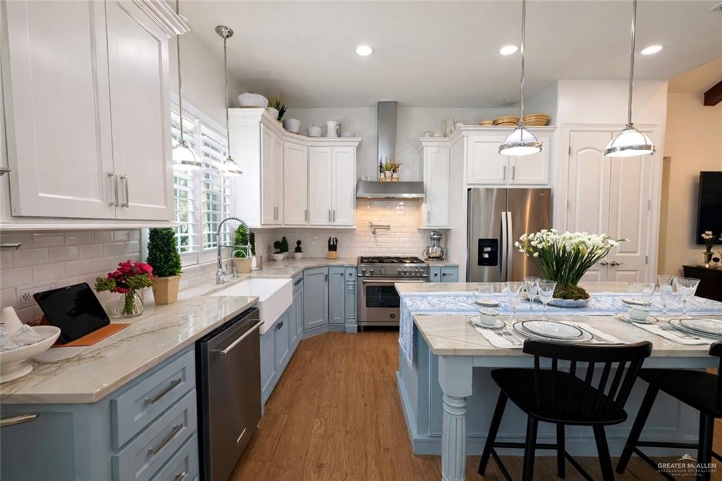 805 Grayson Avenue McAllen, TX 78504 - Photo 6 of 31 a kitchen with granite countertop a sink stainless steel appliances and white cabinets
