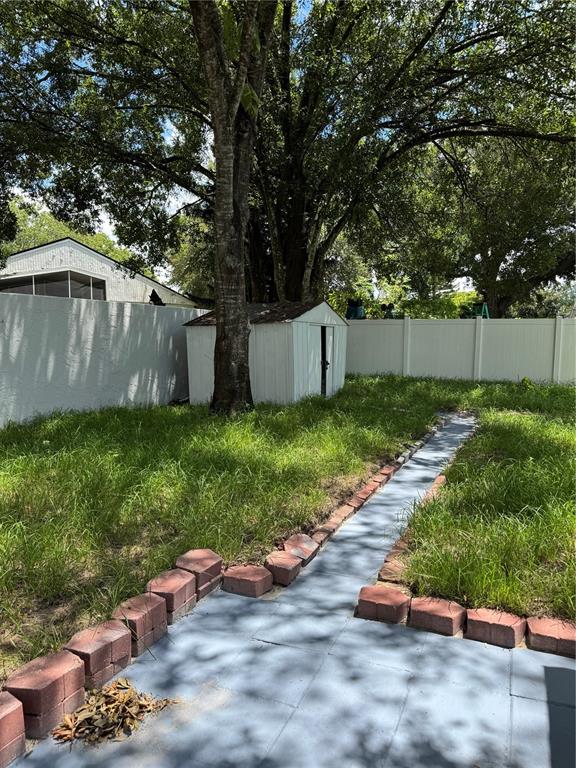 2633 Lanier Road Kissimmee, FL 34744 - Photo 14 of 45 a view of a backyard with plants and large tree