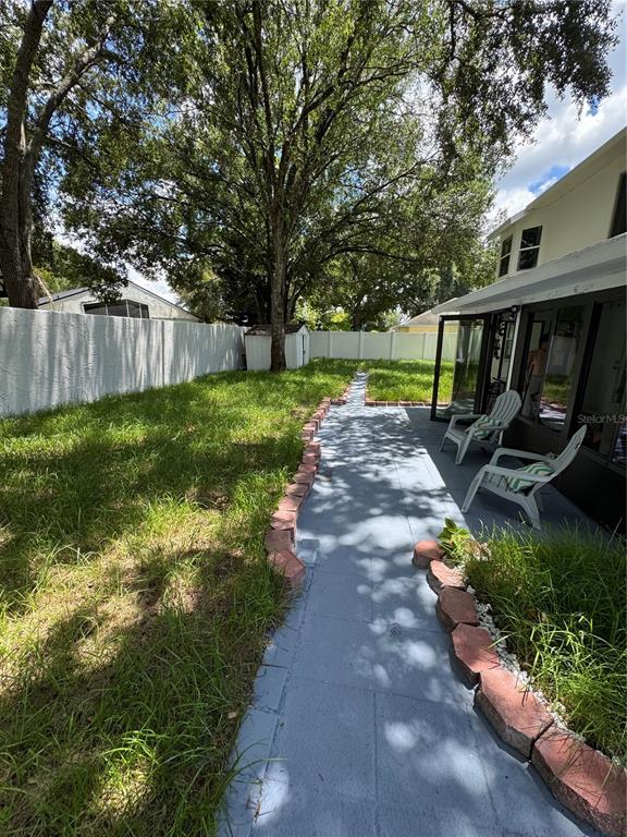 2633 Lanier Road Kissimmee, FL 34744 - Photo 19 of 45 a view of a backyard with wooden fence