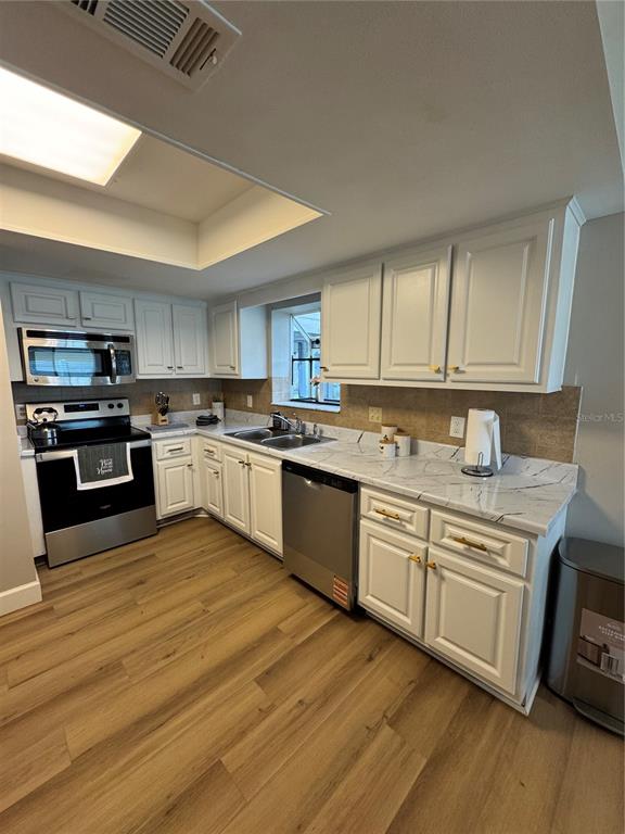 2633 Lanier Road Kissimmee, FL 34744 - Photo 24 of 45 a kitchen with stainless steel appliances granite countertop a stove a sink and a microwave