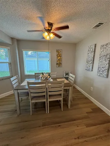 a view of a dining room with furniture and a chandelier
