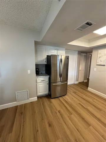 a kitchen with stainless steel appliances a refrigerator and a stove