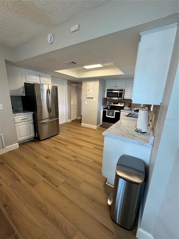 2633 Lanier Road Kissimmee, FL 34744 - Photo 27 of 45 a kitchen with stainless steel appliances granite countertop a refrigerator and a stove