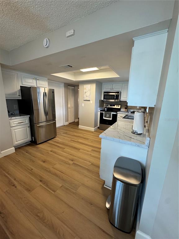 2633 Lanier Road Kissimmee, FL 34744 - Photo 28 of 45 a kitchen with stainless steel appliances granite countertop a refrigerator a stove and a sink