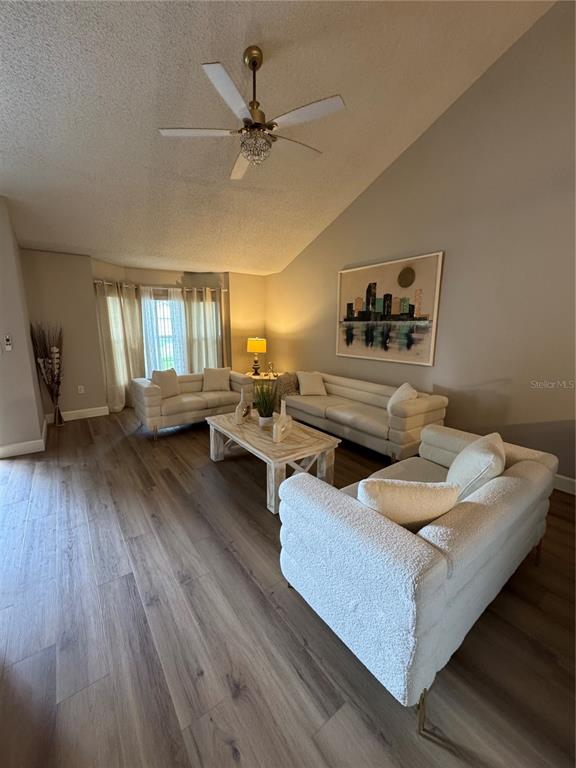 2633 Lanier Road Kissimmee, FL 34744 - Photo 3 of 45 a living room with furniture and wooden floor