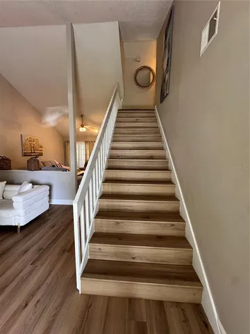 a view of entryway and hall with wooden floor