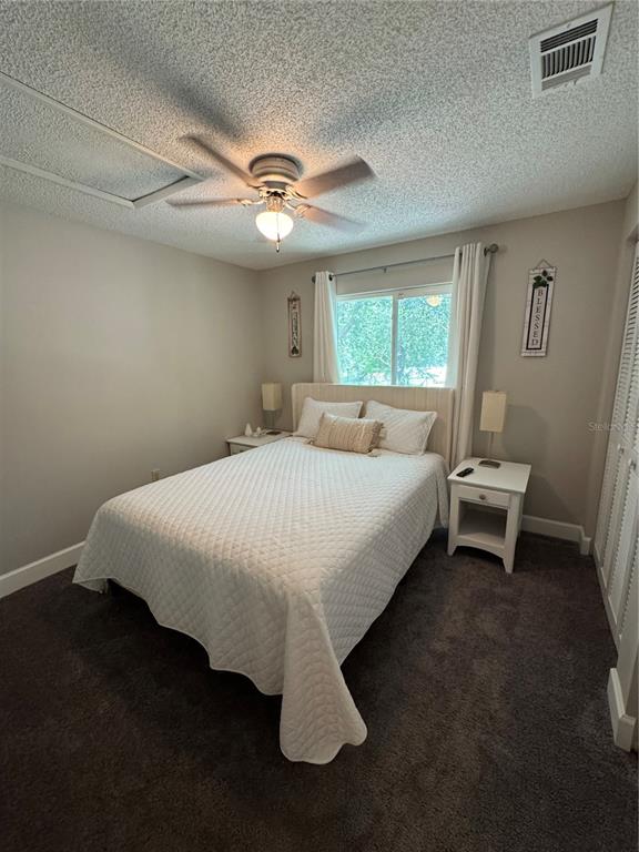 2633 Lanier Road Kissimmee, FL 34744 - Photo 34 of 45 a spacious bedroom with a bed and a window