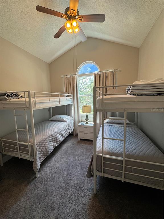 2633 Lanier Road Kissimmee, FL 34744 - Photo 38 of 45 a bedroom with a bed and a chandelier