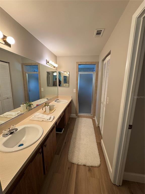 2633 Lanier Road Kissimmee, FL 34744 - Photo 39 of 45 a bathroom with sink double vanity and mirror