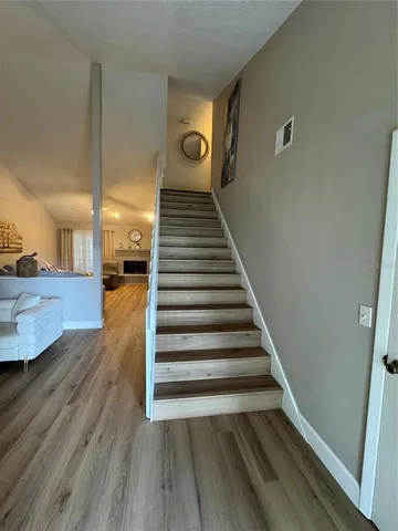 a view of entryway and hall with wooden floor