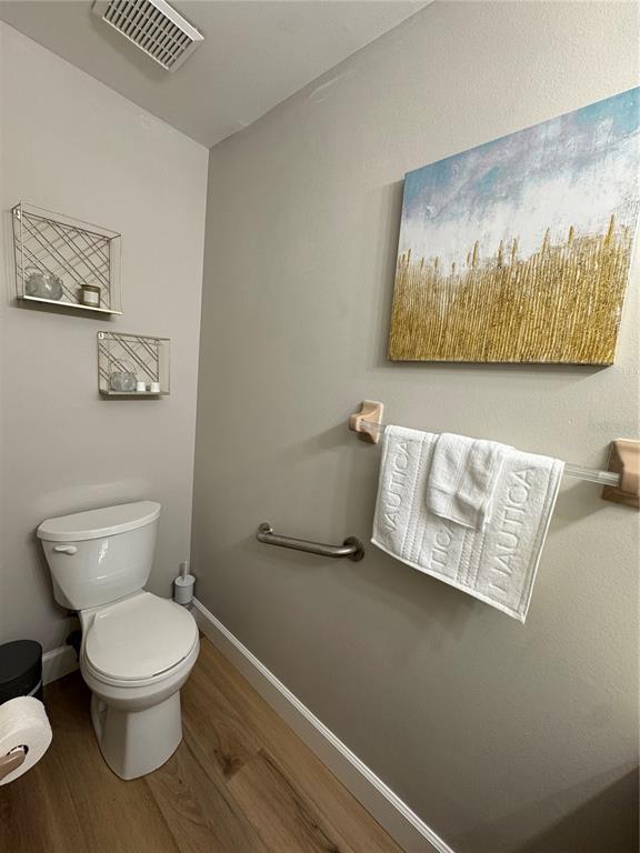 2633 Lanier Road Kissimmee, FL 34744 - Photo 7 of 45 a white toilet sitting next to a bathroom sink